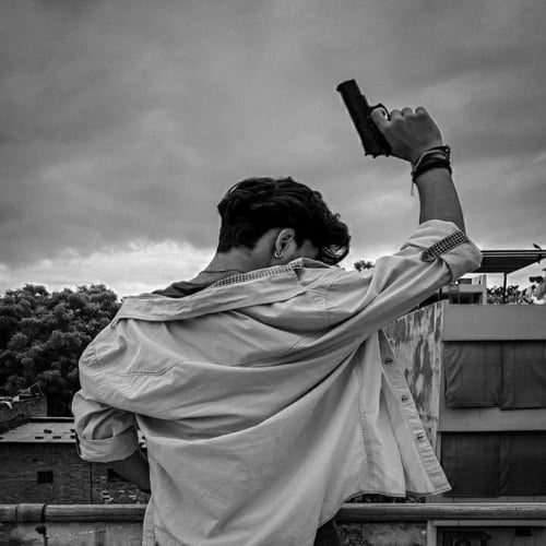 boy holding gun in hand